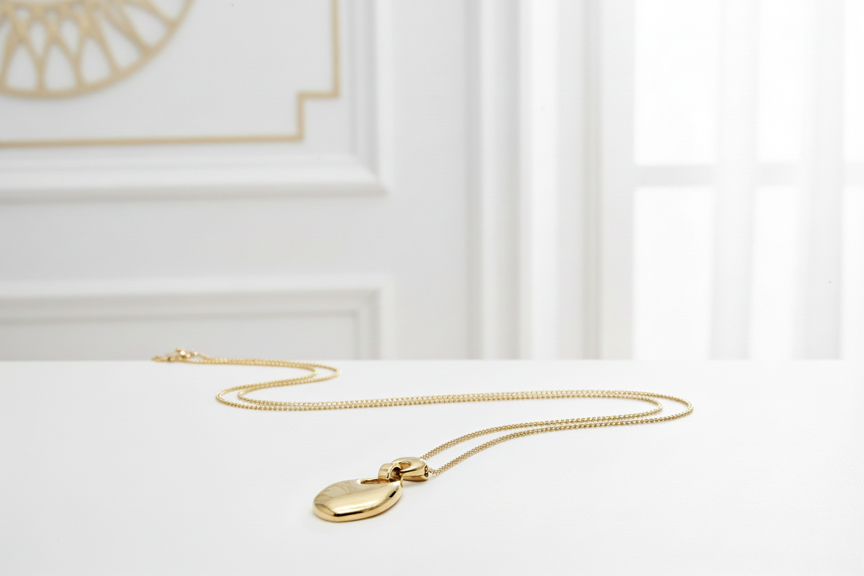 Close-up of long gold pendant necklace in white and gold setting - luxury 18k PVD gold plated stainless steel jewelry