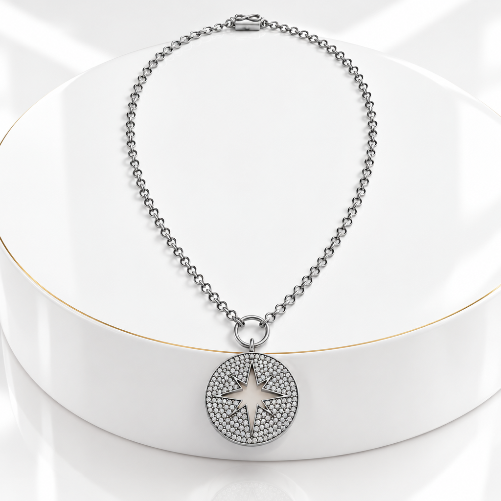 Gunmetal open star pavé pendant with an oxidized sterling silver chain on a white podium with a fine gold edge