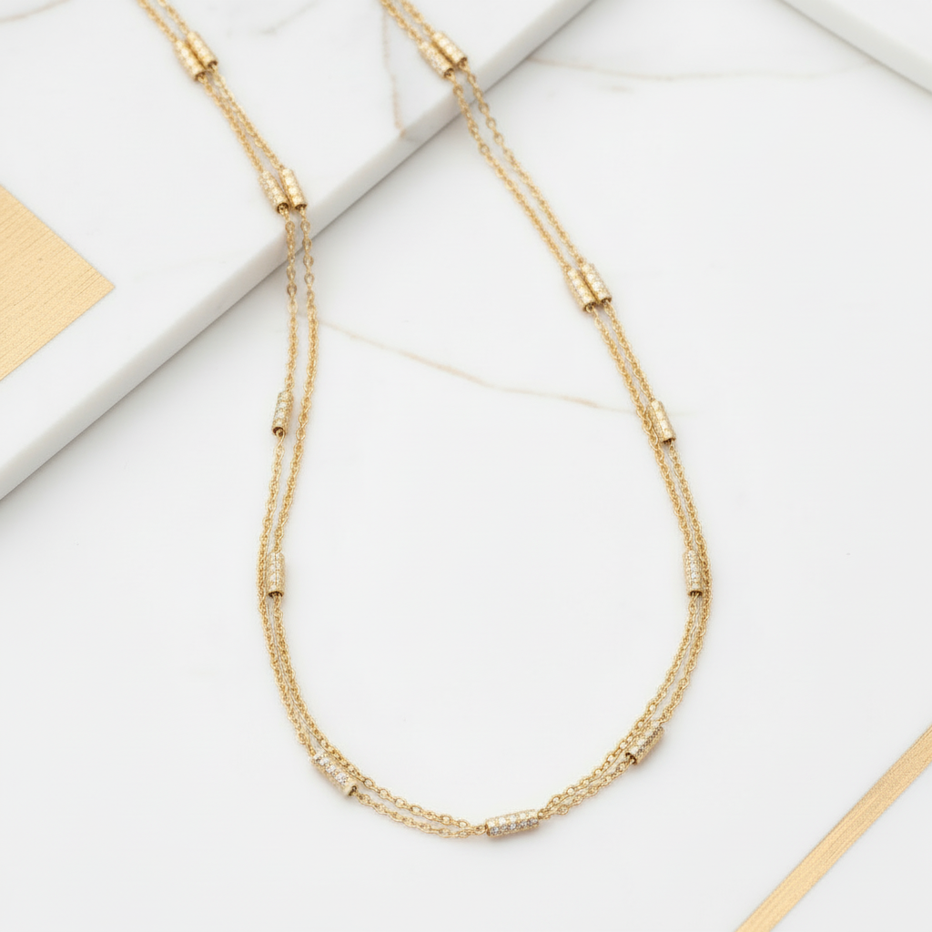 Delicate long gold chain necklace flat lay 18K gold plated versatile jewelry white and gold background