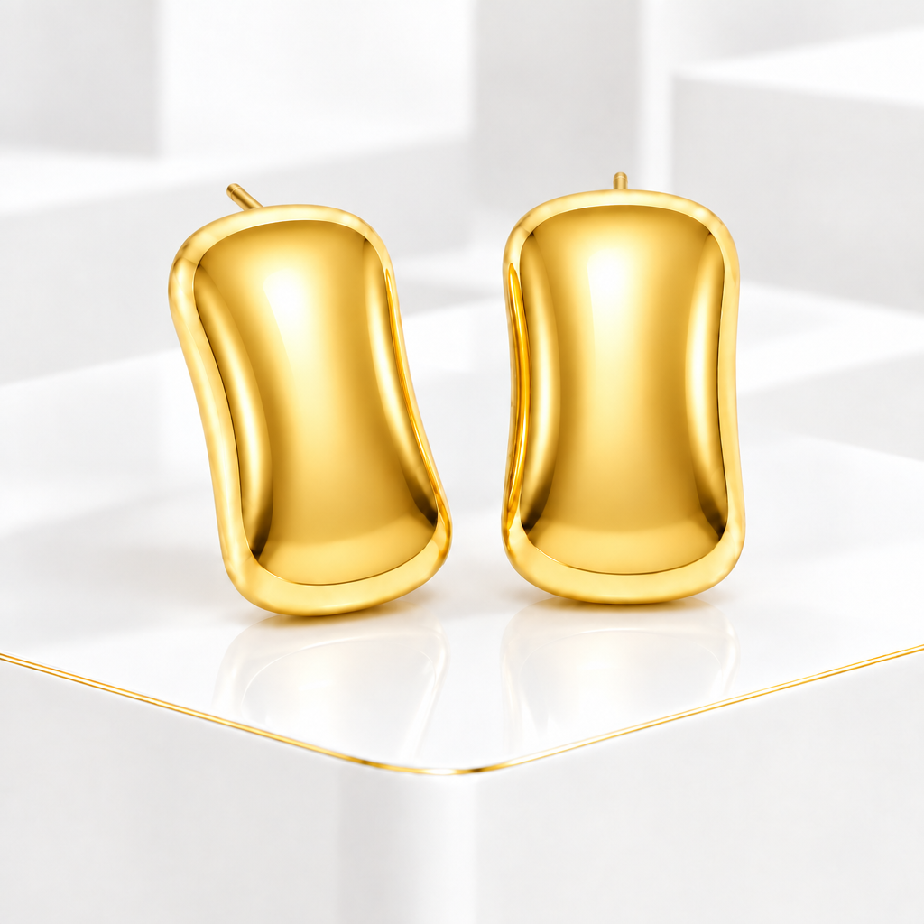 Glossy domed rectangular stud earrings in 18k PVD Gold on a white podium with a fine gold edge