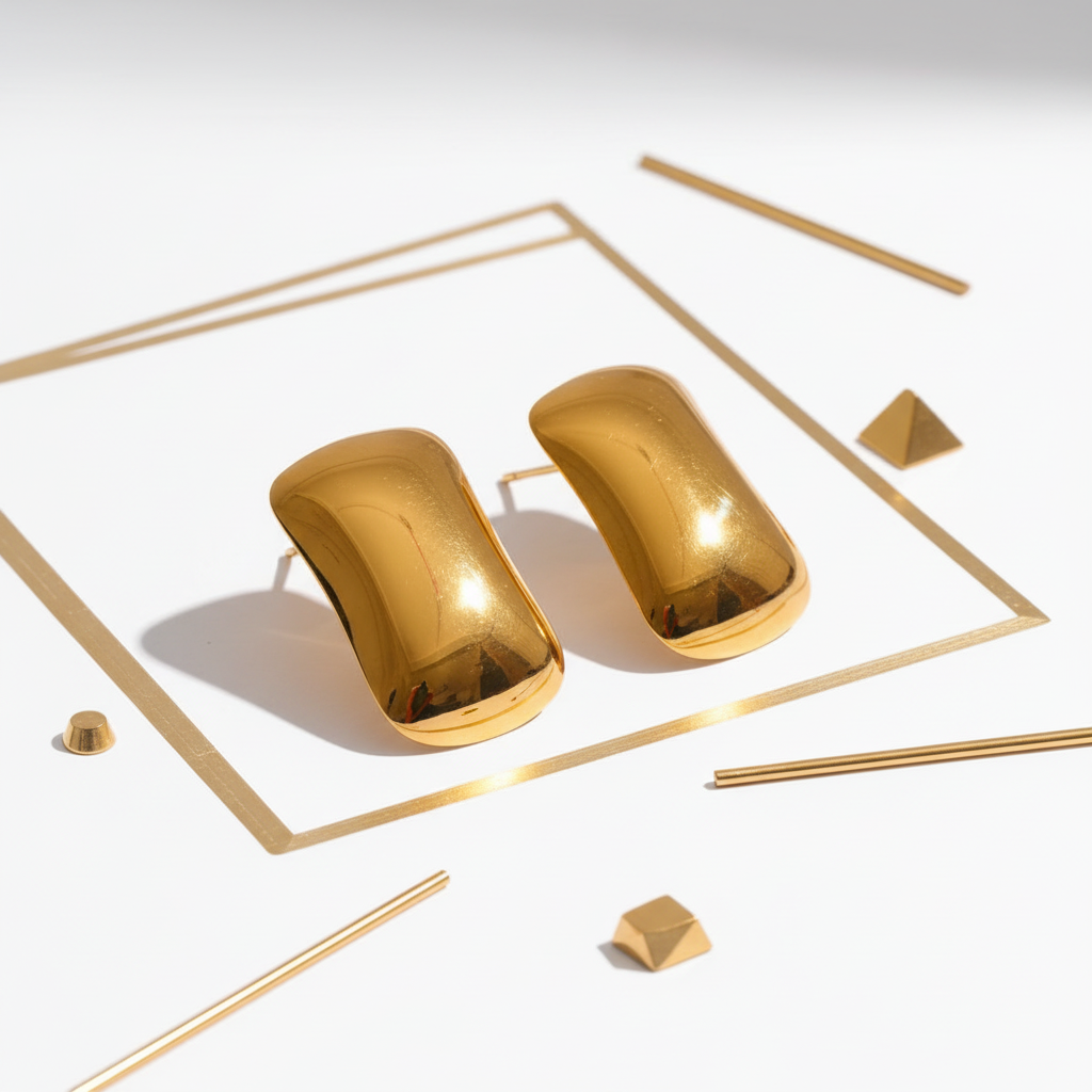 Shiny chunky gold curved stud earrings displayed in white and gold setting - luxury 18k PVD gold plated jewelry