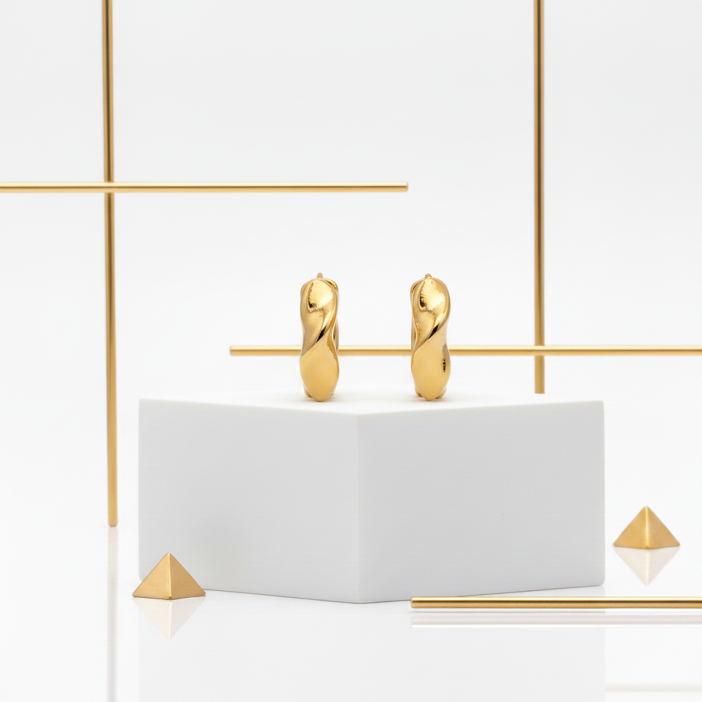Twisted chunky 18K gold plated huggie hoop earrings 16mm on white geometric pedestal