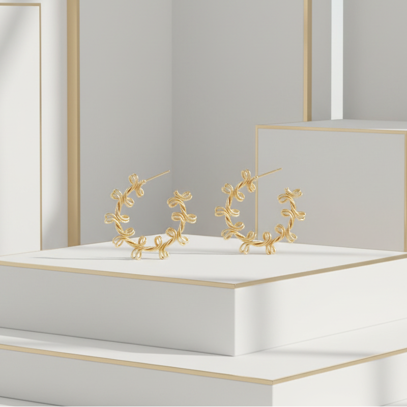 Close-up of 38mm twisted gold hoop earrings in elegant white and gold minimalist setting