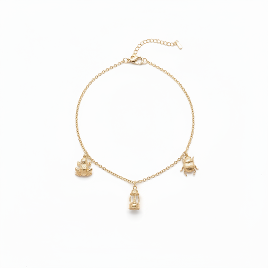 18k gold plated charm necklace with frog lighthouse and scarab beetle charms on white background