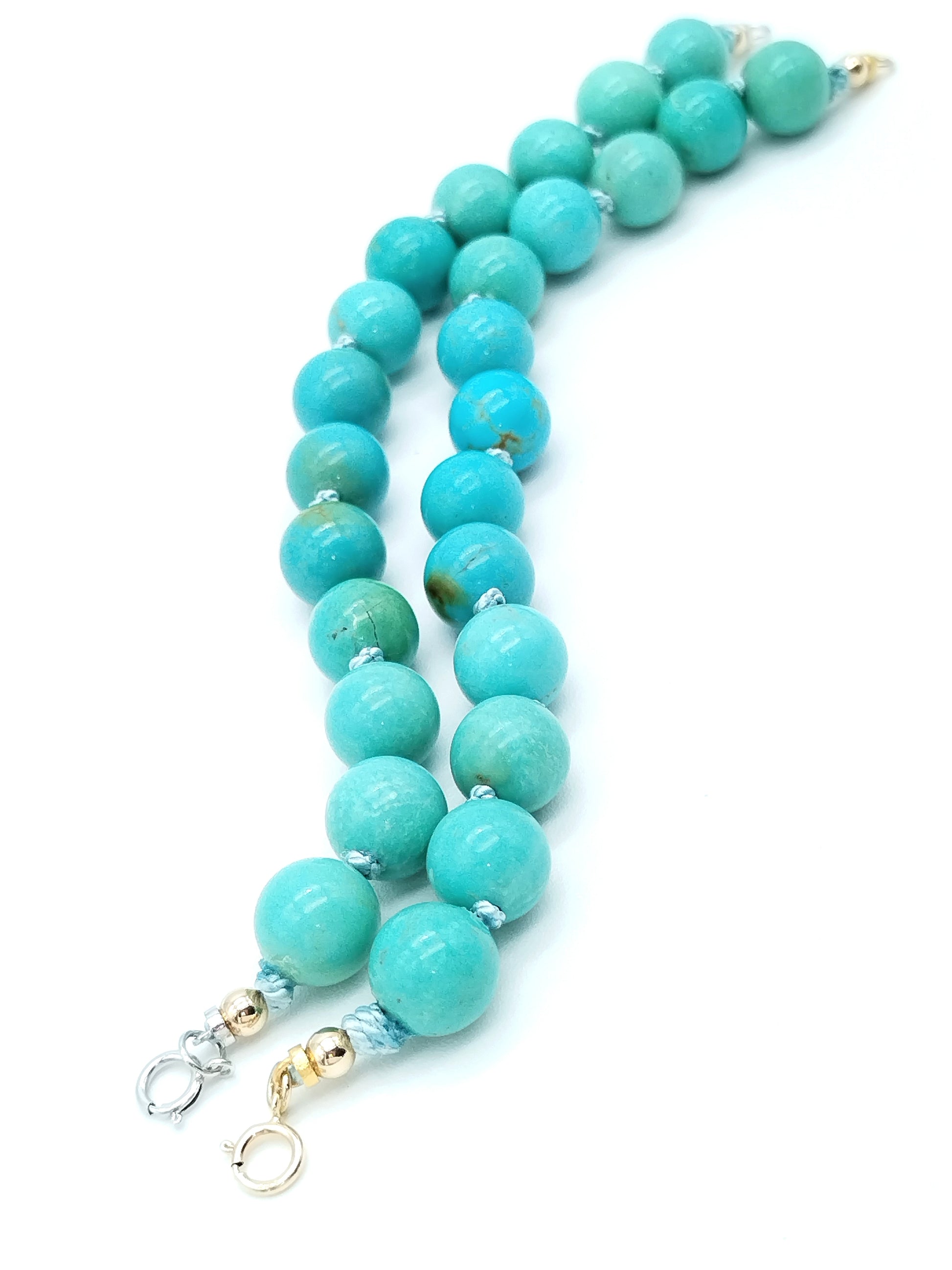 Campitos turquoise bracelet shown at angle highlighting bead quality and gold accent