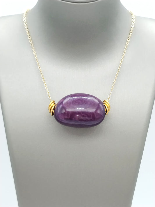 Handmade tagua necklace detail view - eco-friendly purple plum beads