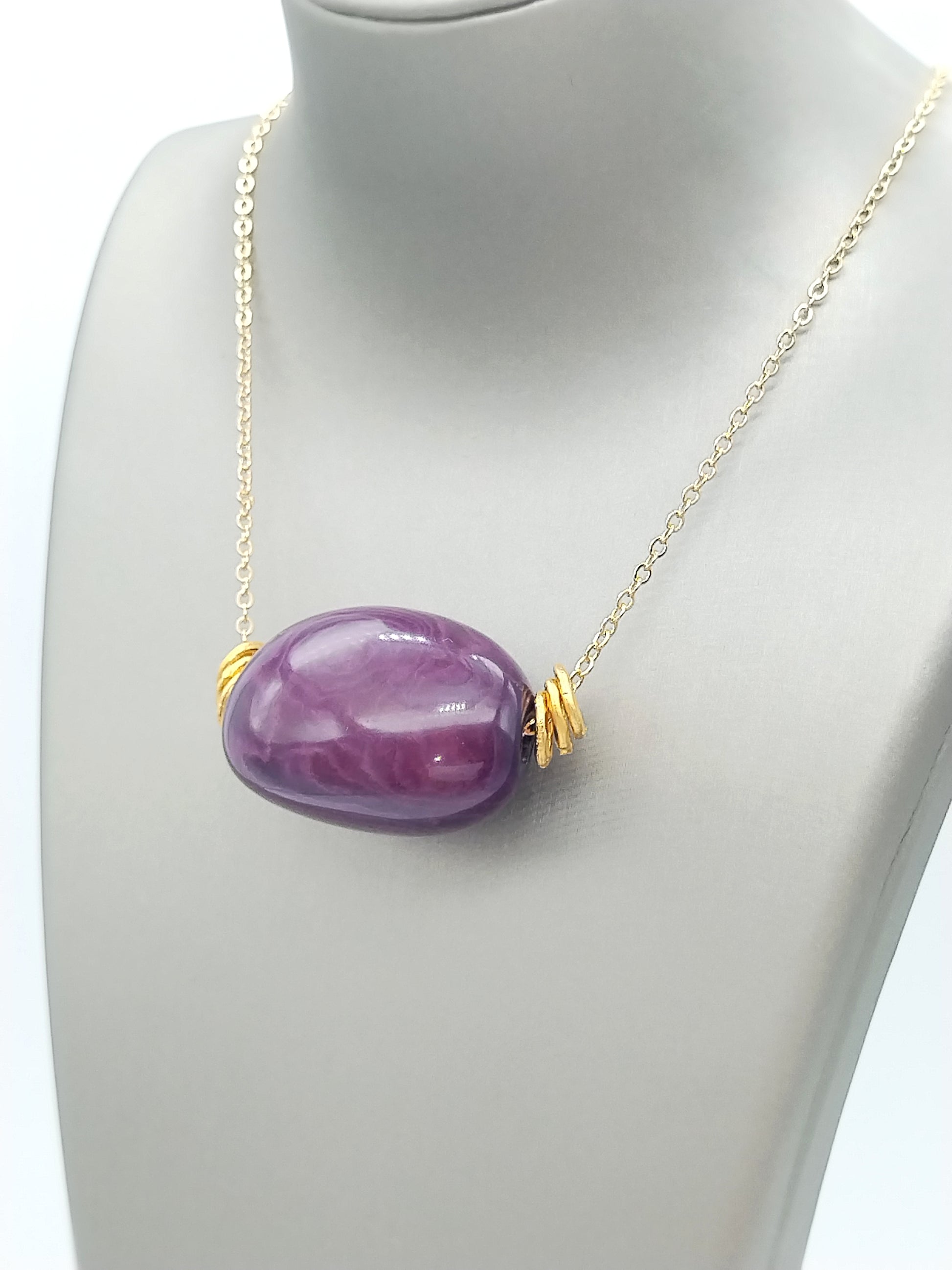Purple-plum tagua necklace close-up showing natural seed beads and handcrafted details