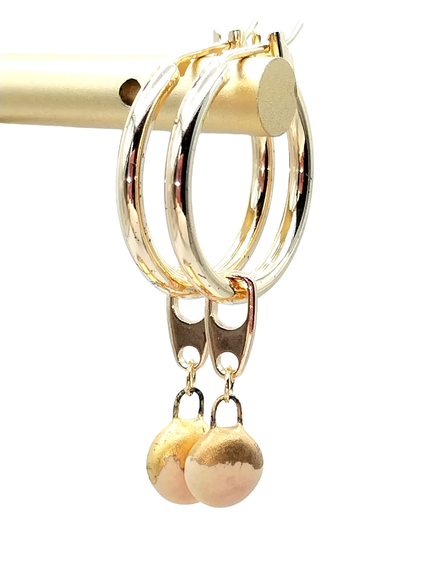 Close-up of gold hoop earrings with removable beige French porcelain charm - artisan handcrafted