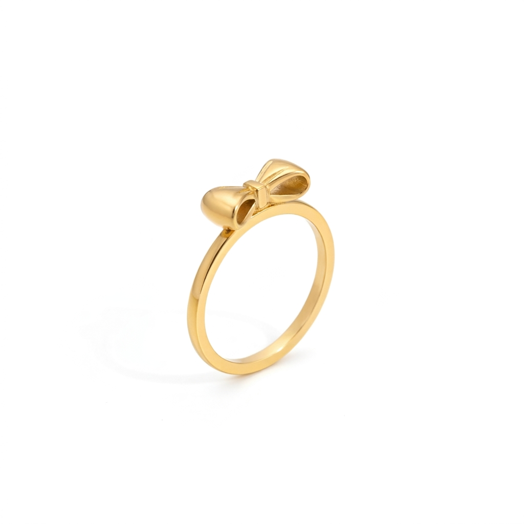 Gold bow ring with a slim polished band shown at a three quarter angle on a white background