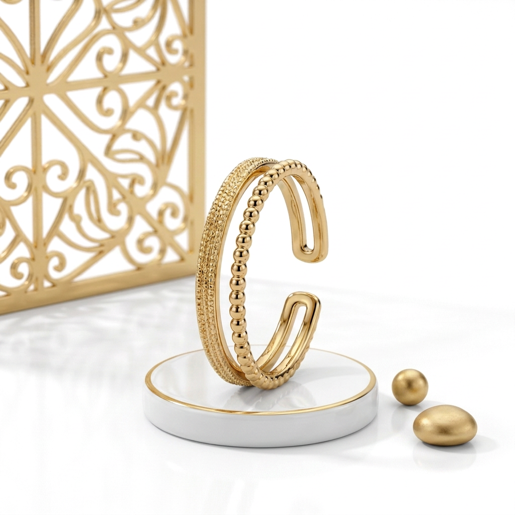 18k Gold Plated double band ring standing on a white pedestal with gold trim, beside ornamental latticework and small matte gold props
