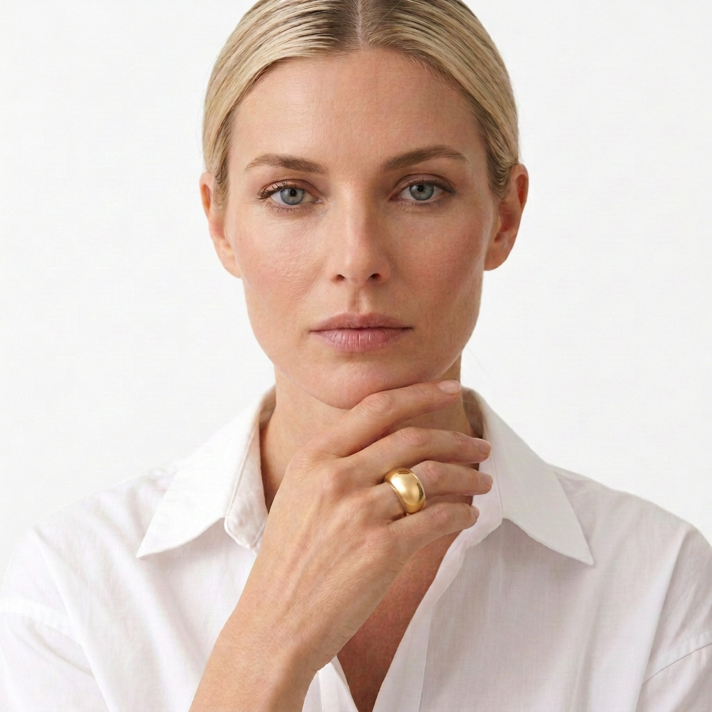 Gold statement ring worn alone with a smooth domed profile