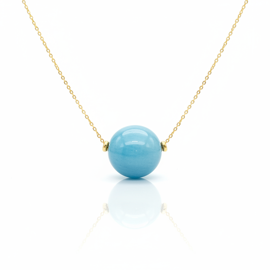 Baby blue tagua bead necklace with 18k gold plated chain on white background