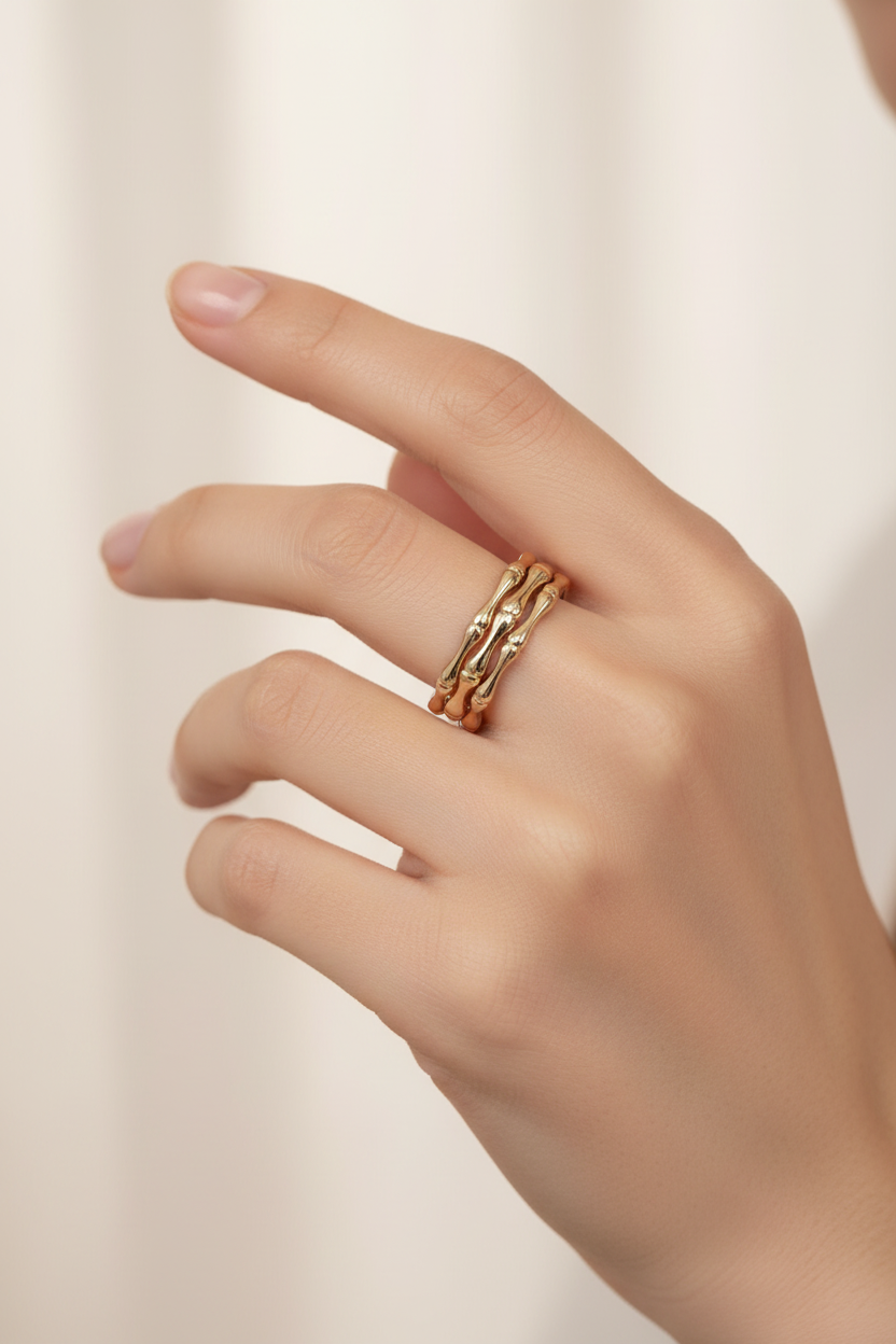 Bamboo gold ring worn on model hand - adjustable triple band stackable ring styling