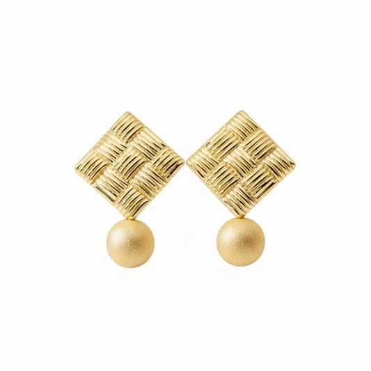 Large gold statement stud earrings with 10mm dangle bead detail, close-up view