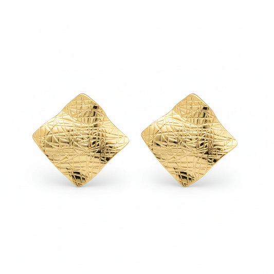 Close-up of chunky wavy gold stud earrings with geometric diamond silhouette on white background | Ms Friesch

