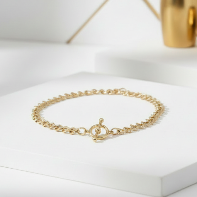 Chunky 18K gold plated cable chain necklace with toggle clasp displayed on white and gold background
