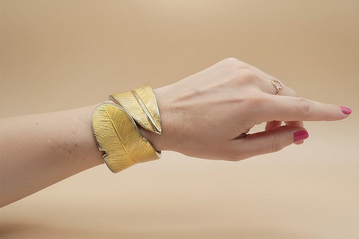 Model wearing chunky gold cuff bracelet - lifestyle shot showcasing 18k gold plated open bangle