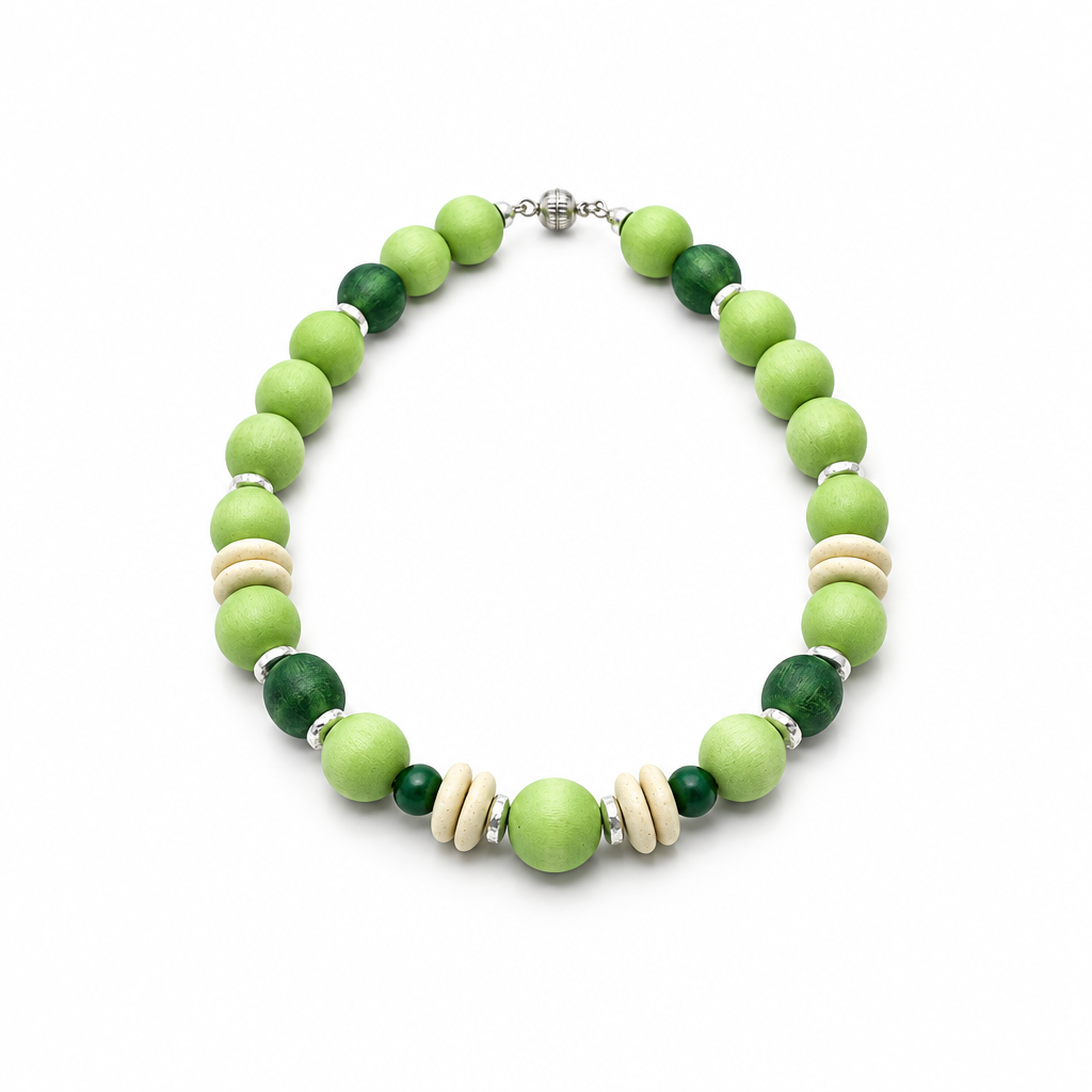 Chunky apple-green and dark green bead necklace with cream discs and silver-tone spacers on a white background