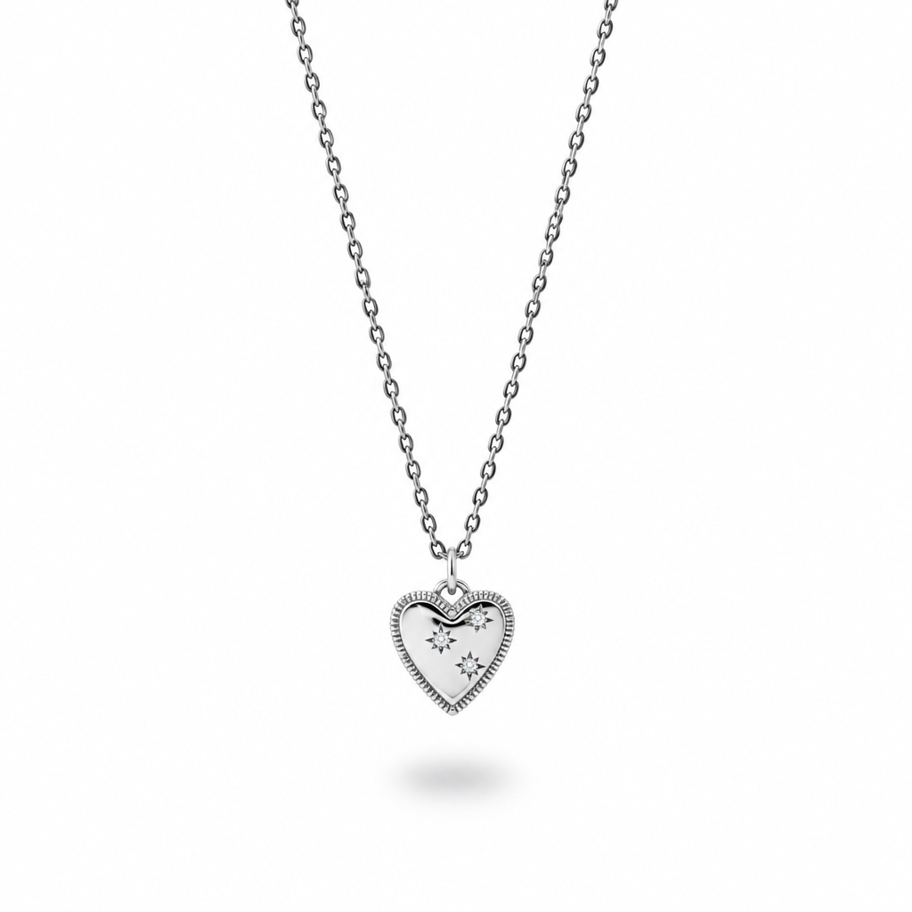 Silver plated heart pendant with three cubic zirconia stones on an oxidized sterling silver chain against a white background