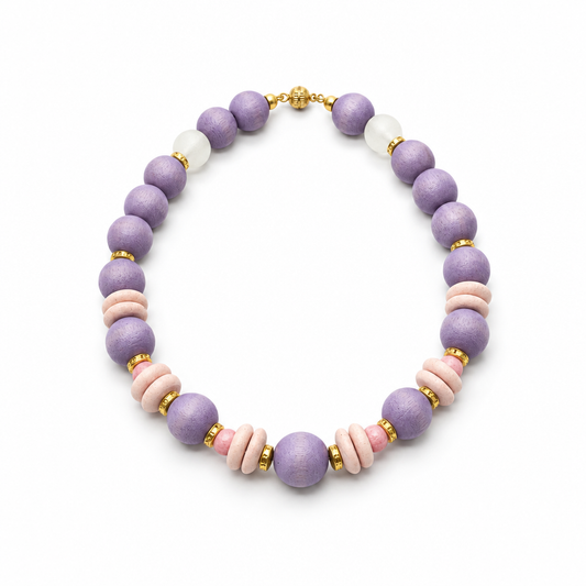 Lavender wood bead necklace with blush pink discs, African glass beads and gold-tone accents on a white background