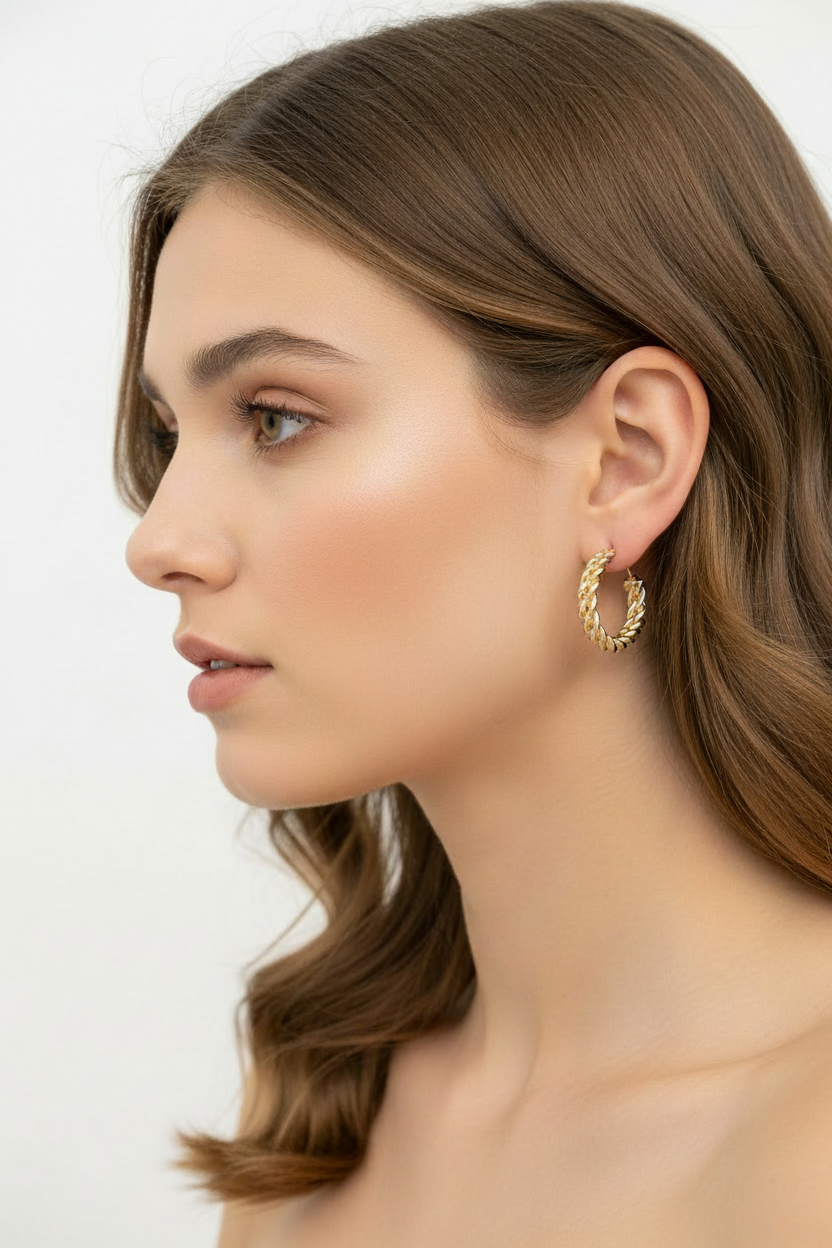 Chunky gold hoop earrings worn by model braided textured hoops 18k gold plated stud earrings luxury jewelry for women
