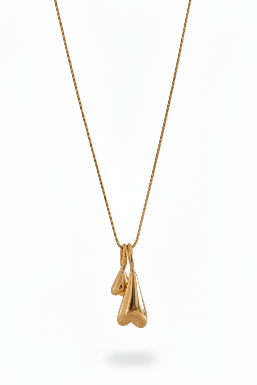 Double domed heart chain necklace 18k PVD gold stainless steel pendant on white background
