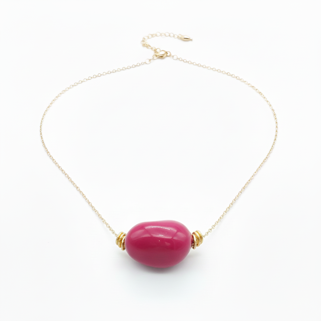Fuchsia tagua nugget necklace with 18k gold plated chain on white background - sustainable vegetable ivory jewelry
