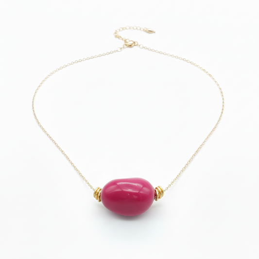 Fuchsia tagua nugget necklace with 18k gold plated chain on white background - sustainable vegetable ivory jewelry