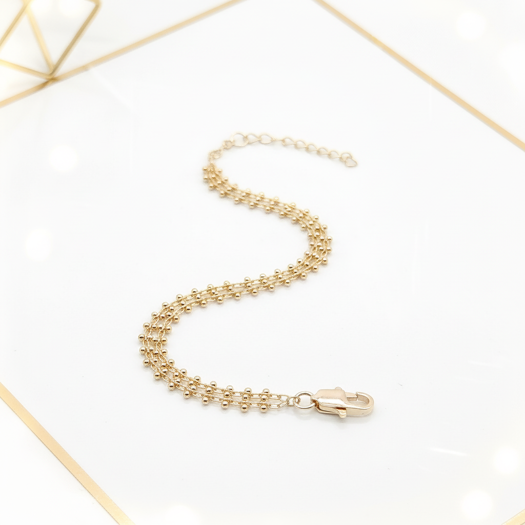 Delicate 18k gold double chain bracelet in white and gold editorial setting | Ms Friesch