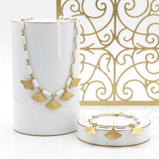 Matching ginkgo leaf necklace and bracelet set with white enamel links and textured gold tone charms