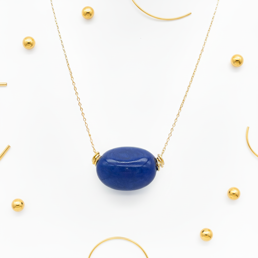 Navy blue tagua nugget necklace 18k gold plated displayed on white and gold background, eco-friendly handcrafted jewelry