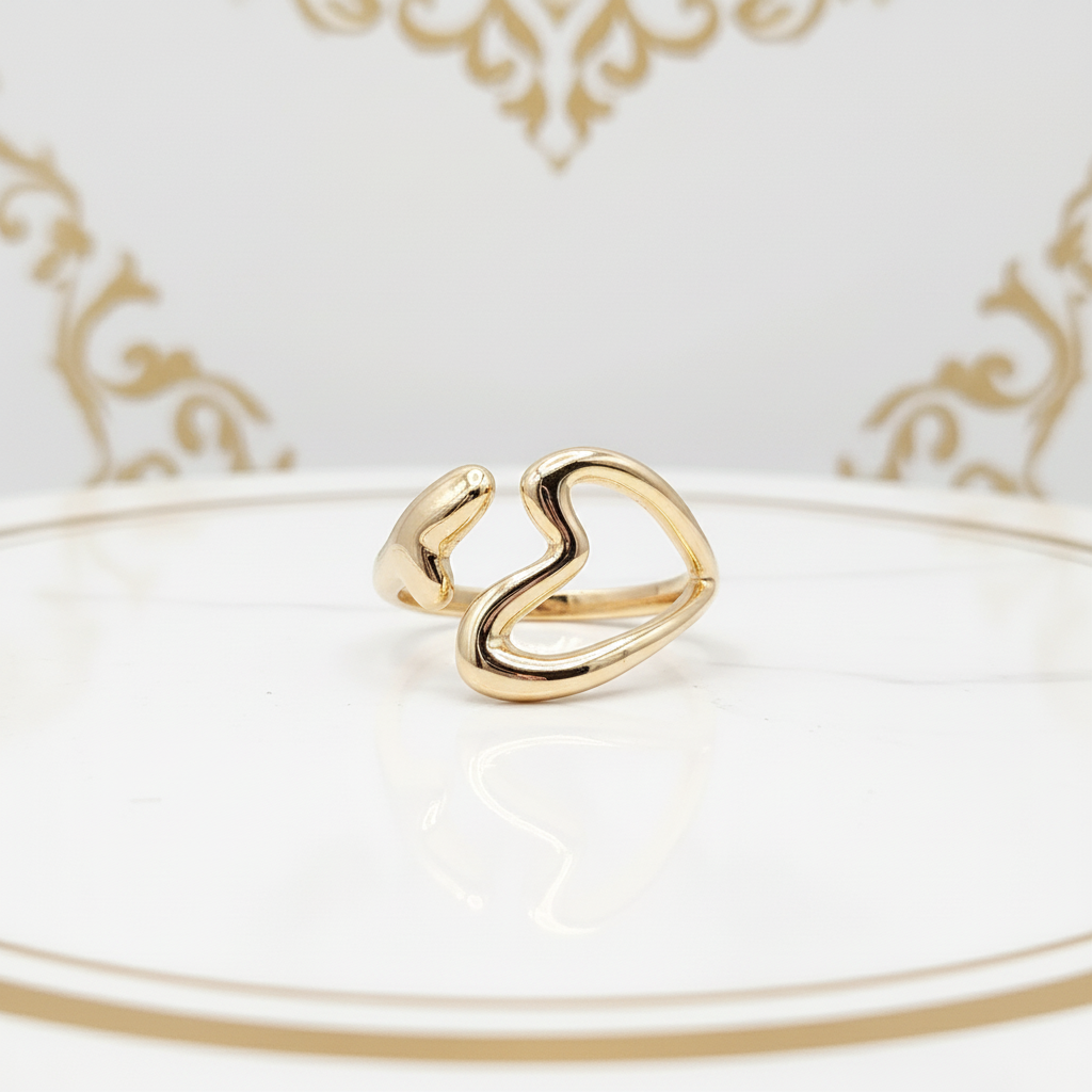 Close-up of delicate open heart design on 18k gold plated adjustable ring - hypoallergenic water-resistant jewelry