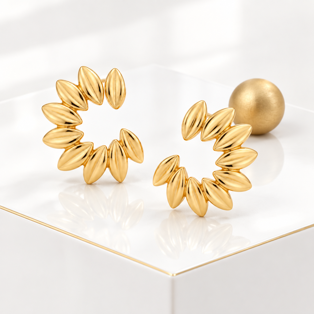 Flower petal open hoop earrings on a glossy white podium with a fine gold edge and a matte gold sphere behind