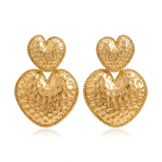Hammered double heart drop earrings with beaded edges on a white background