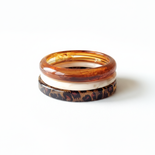 Animal print, beige and amber resin bracelet set stacked on white background - 6.5cm diameter stackable bangles