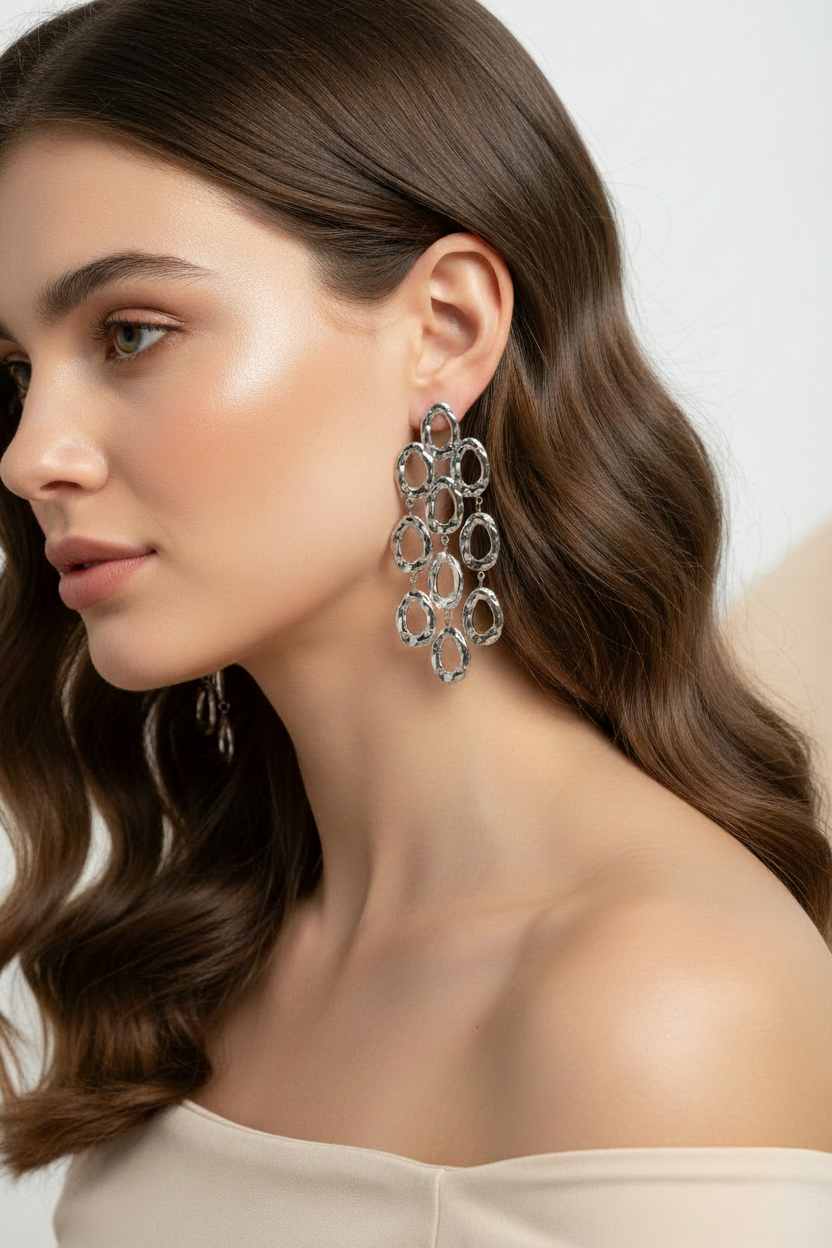 Woman wearing long silver circle fringe dangle stud earrings