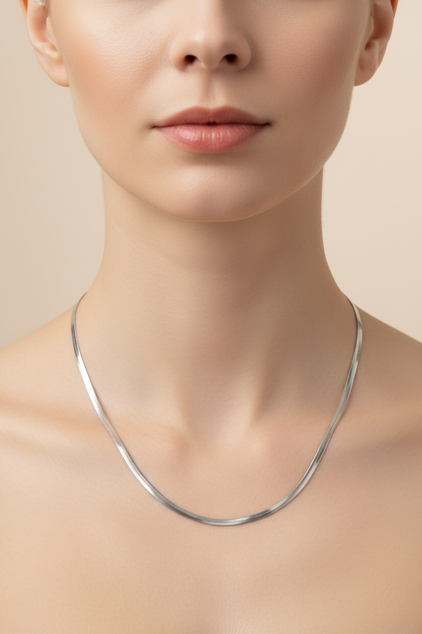 Silver snake chain necklace worn longer on model