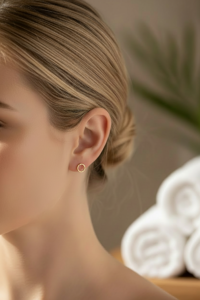 Woman wearing small open circle stud earrings 7mm minimalist geometric jewelry