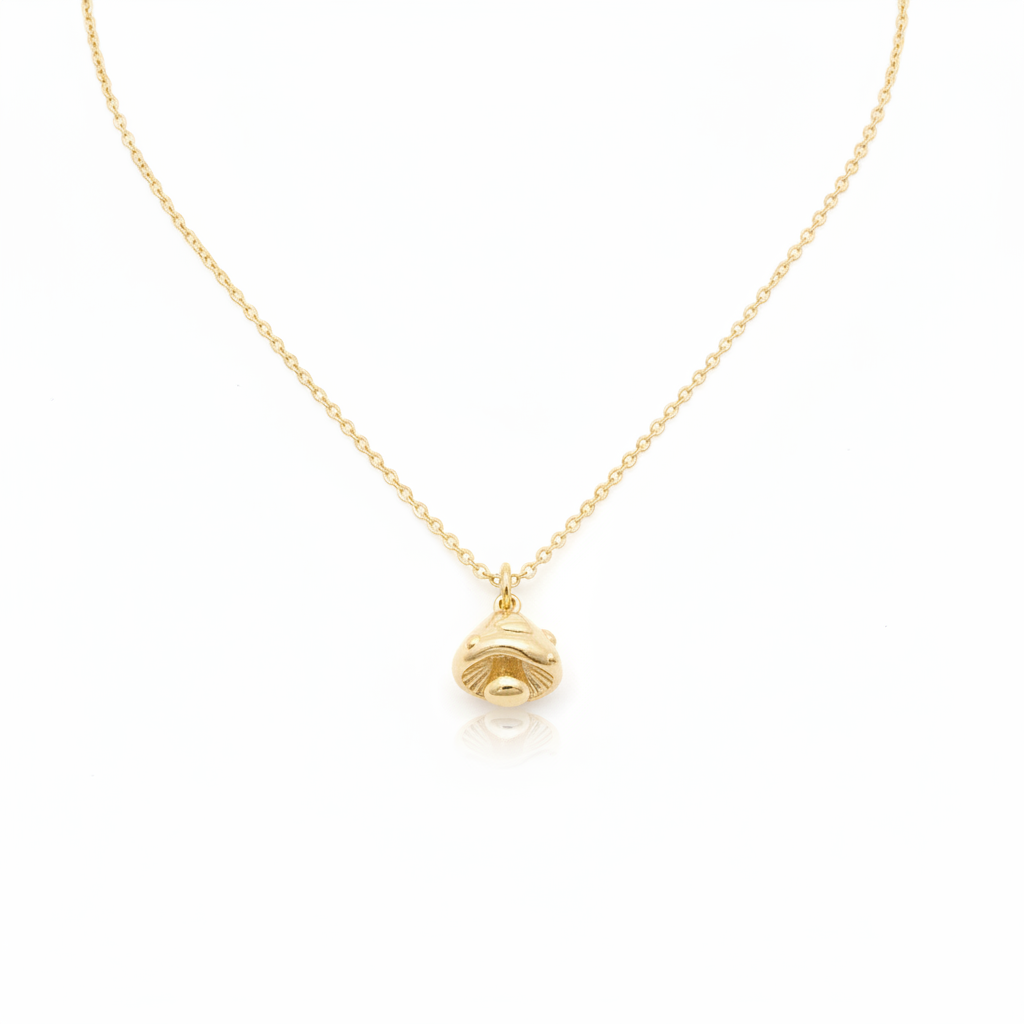 Tiny Gold Mushroom Charm Necklace with shadows