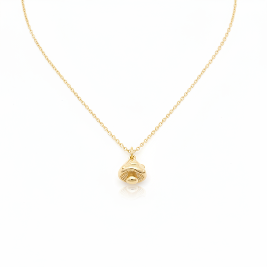 Tiny Gold Mushroom Charm Necklace with shadows